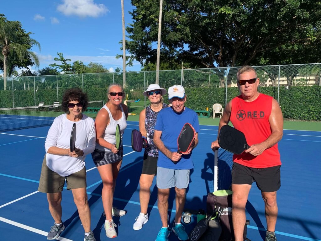 Bob teaching an Advanced Beginners Pickleball Clinic in Delray Beach with Allison, Franye, Michael, and Carol.